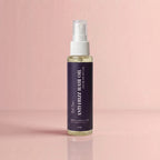 Bottle of Antifrizz Hair Oil on a pink background