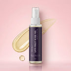 Anti-frizz hair oil bottle with a droplet on a pink background