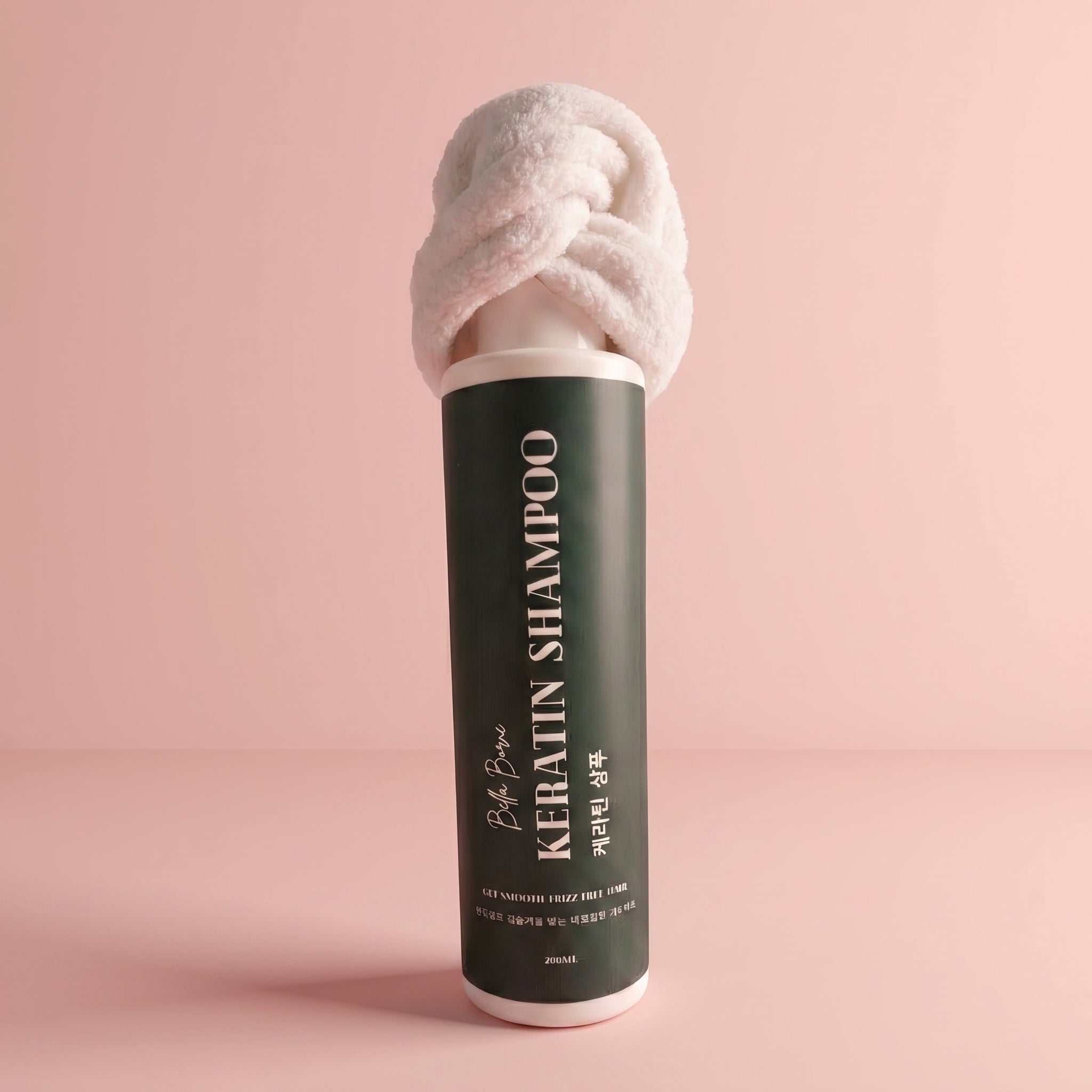 Keratin shampoo bottle with towel on a pink background