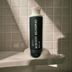 Bottle of shampoo on a sink with tiled wall background